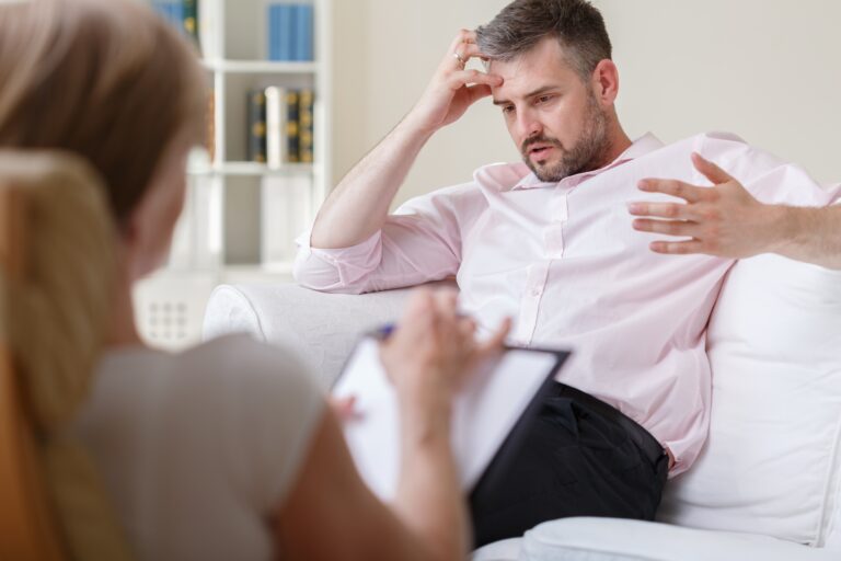 man speaking to therapist during therapy session