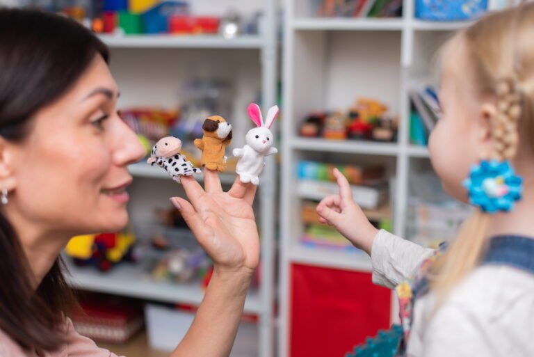 smiling therapist with child during play therapy in York